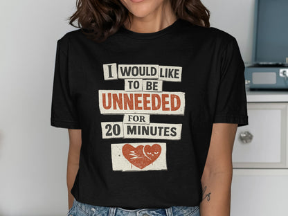 Black t-shirt with text "I WOULD LIKE TO BE UNNEEDED FOR 20 MINUTES" and a stylized heart.