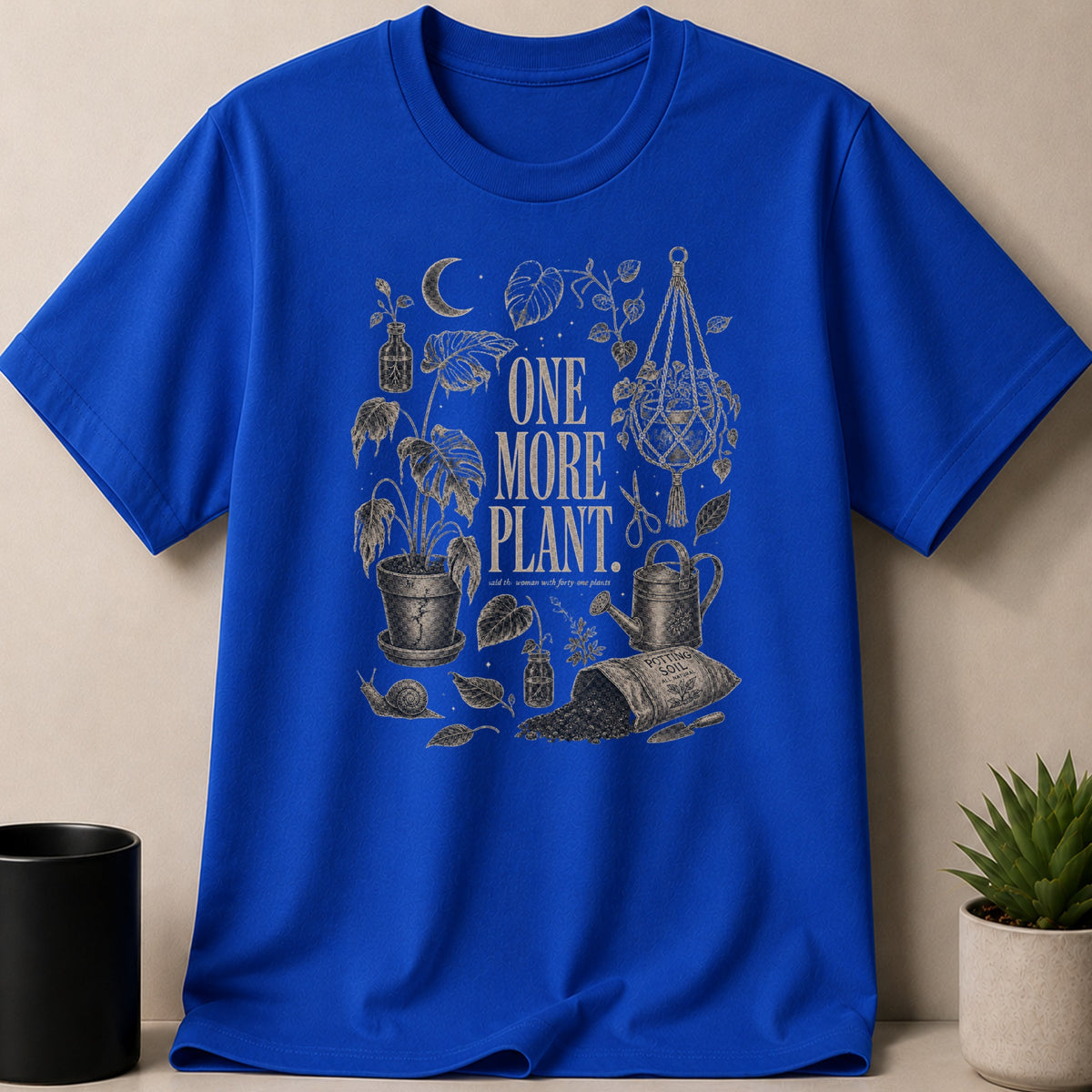 Royal blue t-shirt with "ONE MORE PLANT. said the woman with forty-one plants" text and gardening imagery.