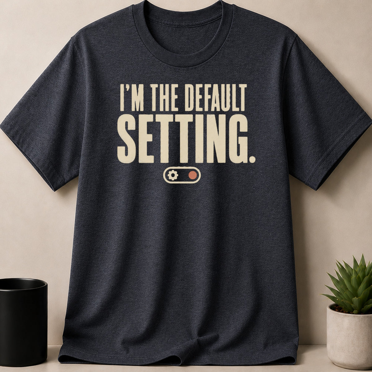 Dark grey t-shirt with "I'M THE DEFAULT SETTING." text and gear graphic.