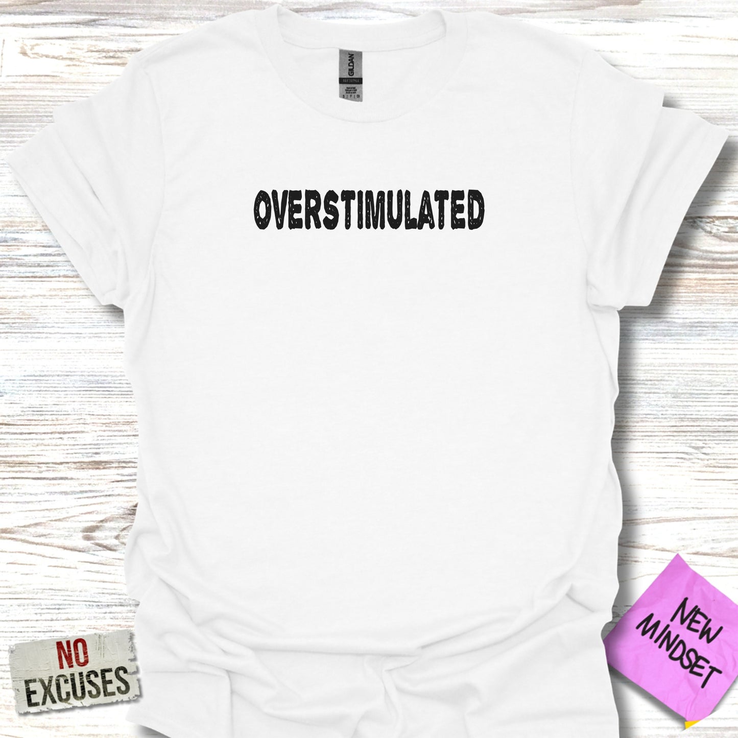 White t-shirt with "OVERSTIMULATED" and "NO EXCUSES NEW MINDSET" text.