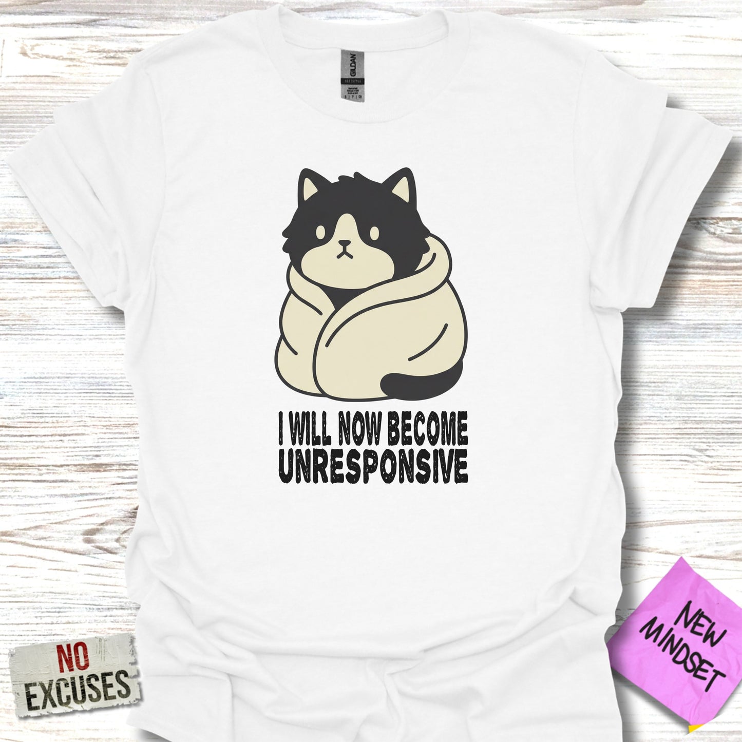 White t-shirt with cartoon cat wrapped in blanket, text "I WILL NOW BECOME UNRESPONSIVE".
