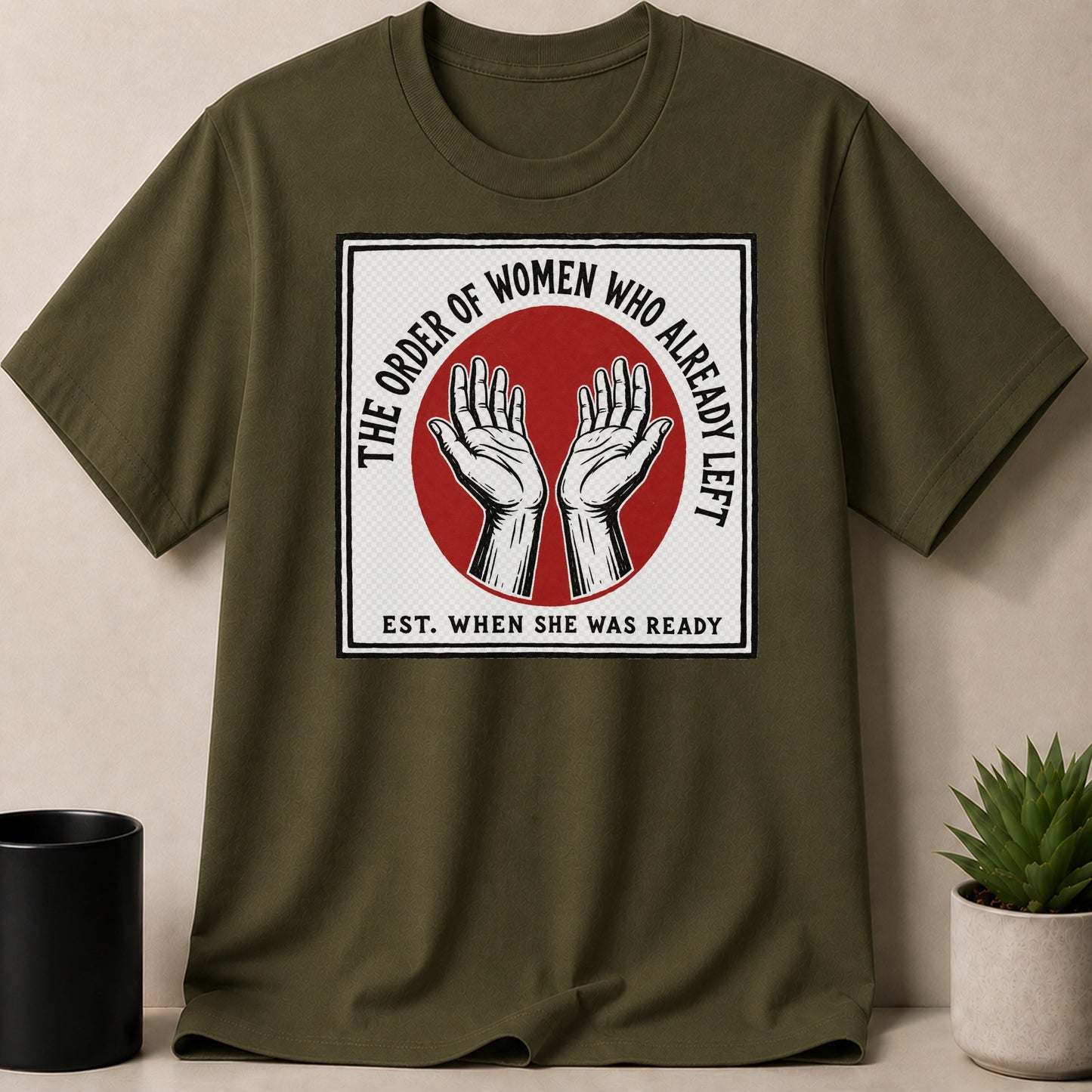 Green t-shirt with "The Order of Women Who Already Left" text and hands.