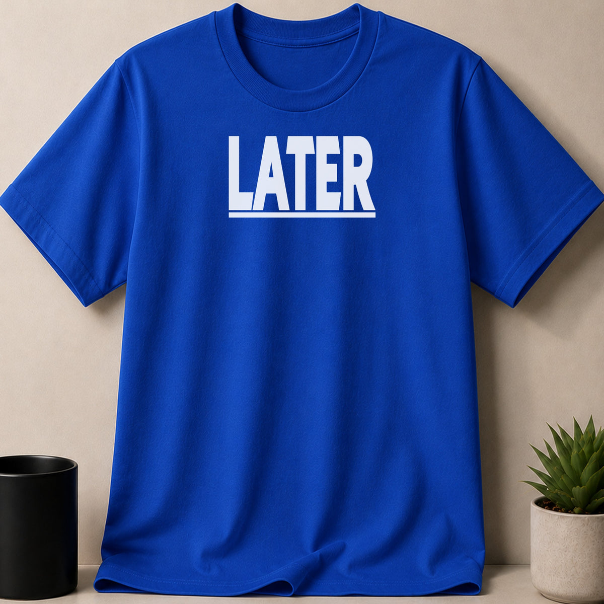 Royal blue t-shirt with white text that reads "LATER" above a thin horizontal line.