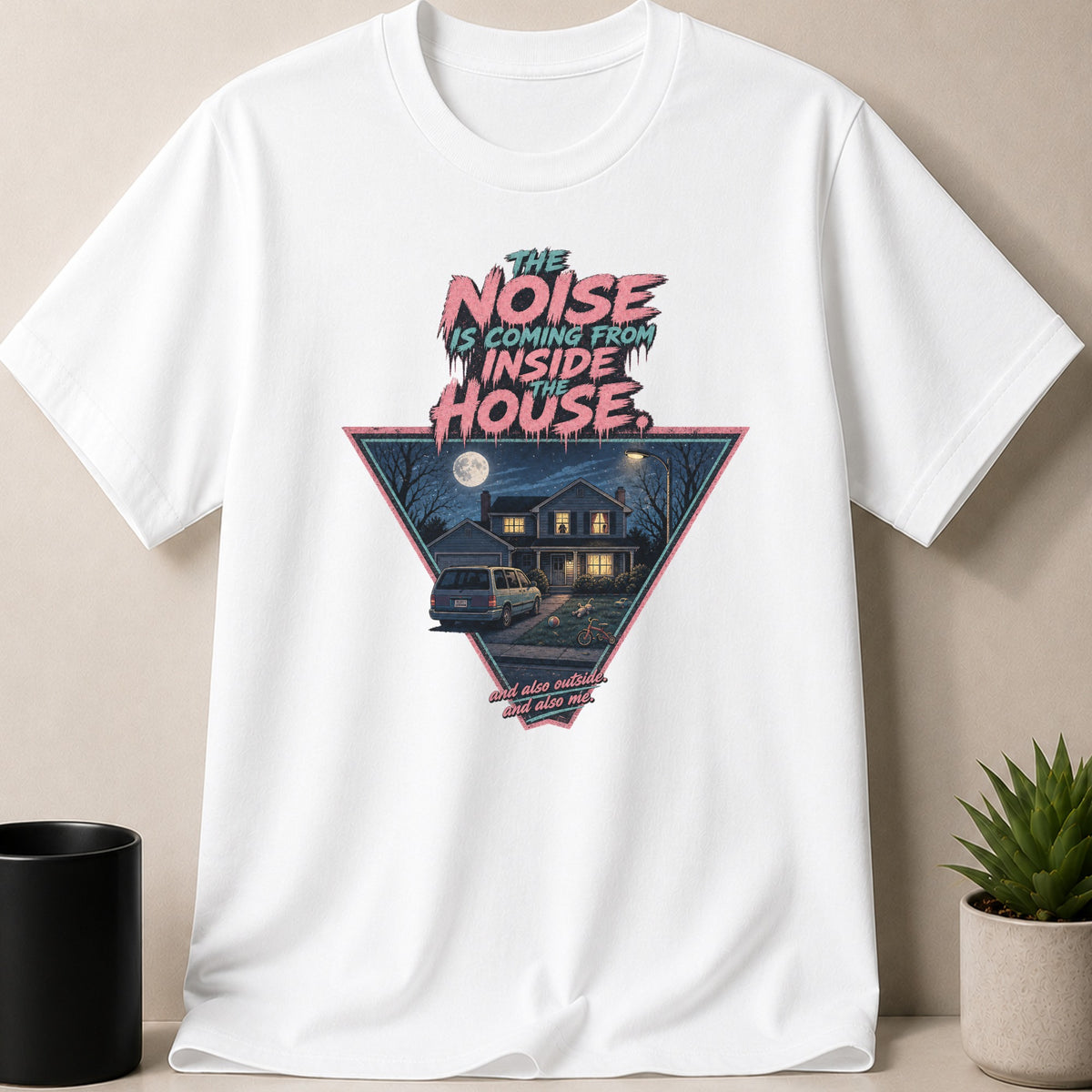 White t-shirt with graphic "The Noise Is Coming From Inside The House" and a triangular scene.