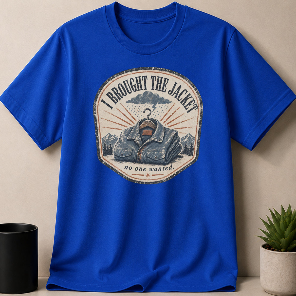 Royal blue t-shirt with a graphic that reads "I BROUGHT THE JACKET no one wanted."