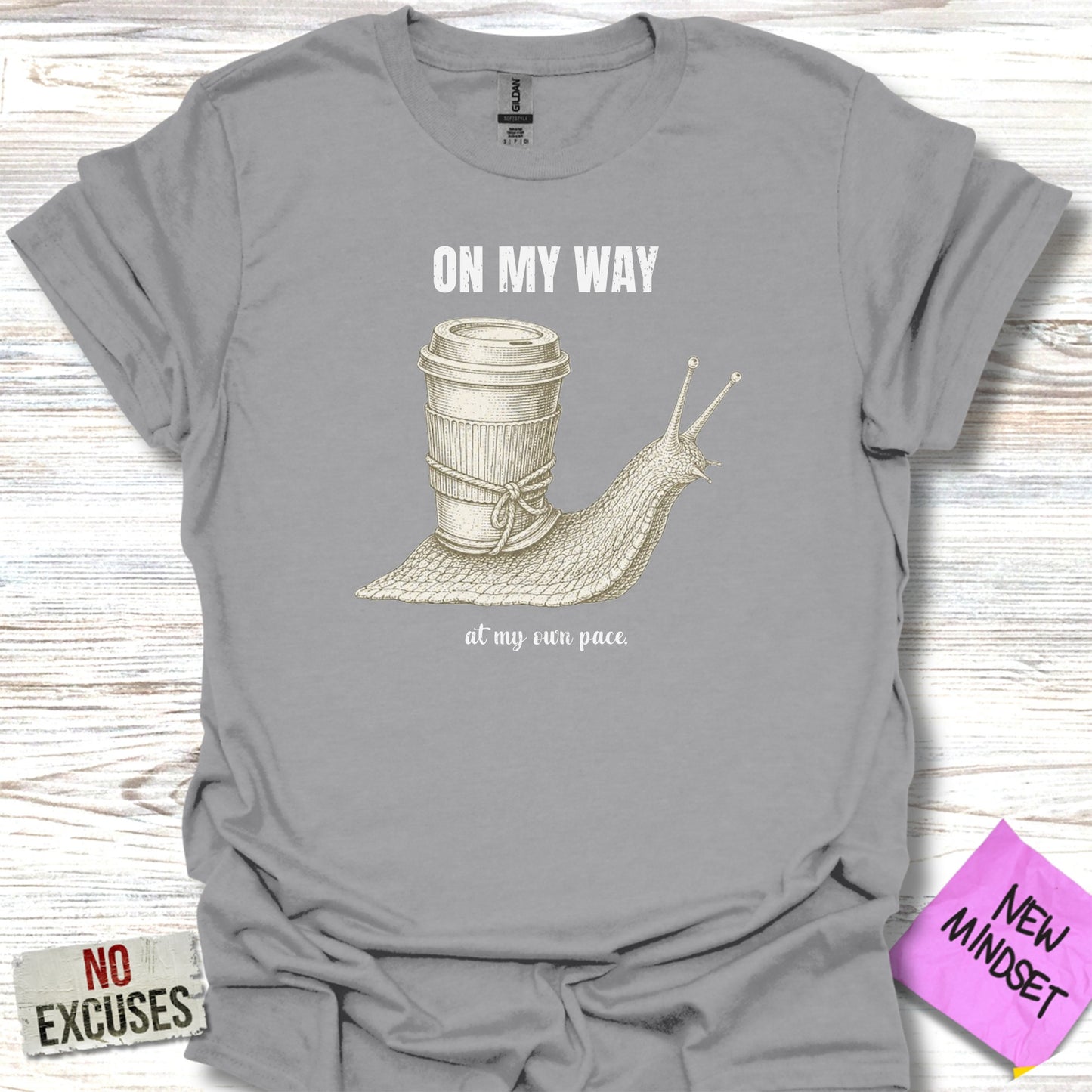 T-shirt with a snail carrying a coffee cup, text reads "ON MY WAY at my own pace."