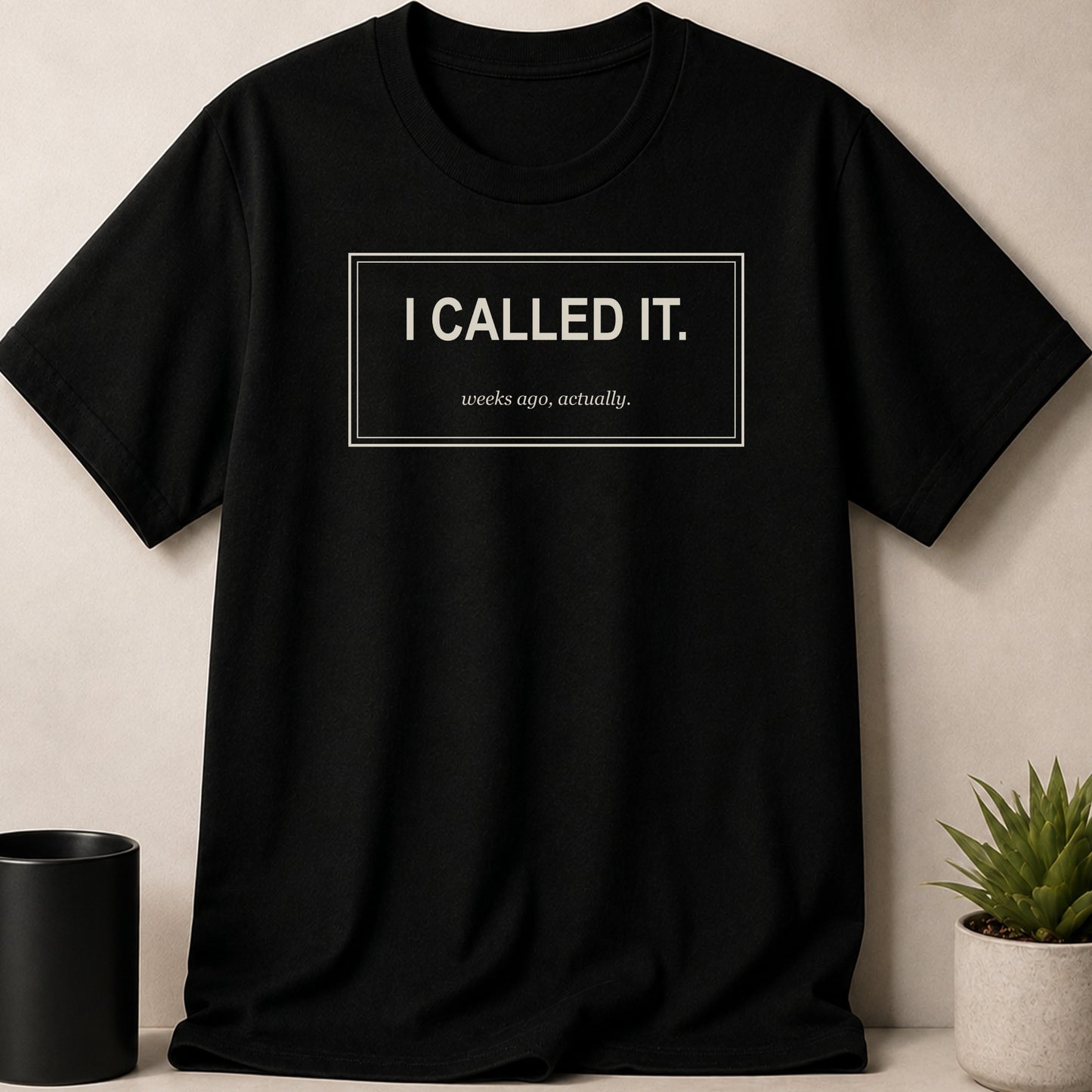Black t-shirt with white text reading "I CALLED IT." and "weeks ago, actually."