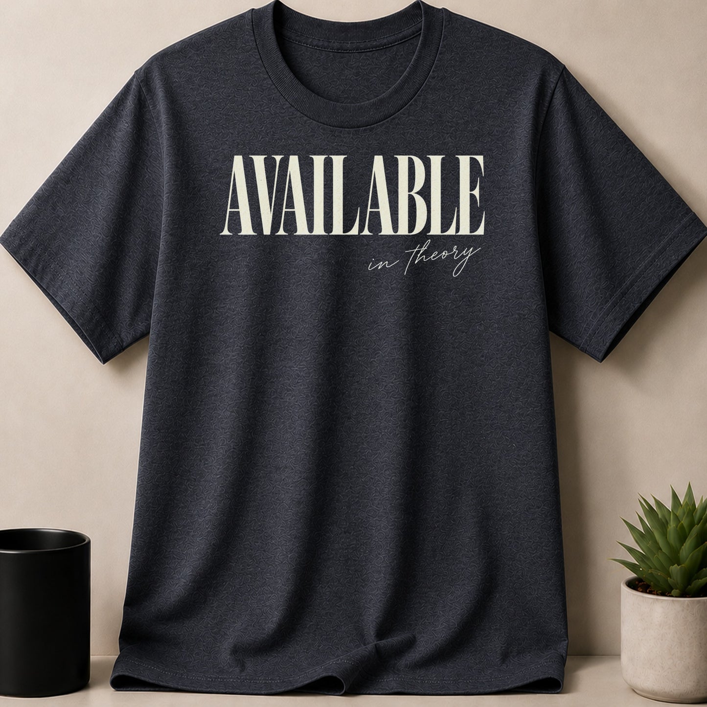 Dark grey t-shirt with "AVAILABLE in theory" printed in cream text.