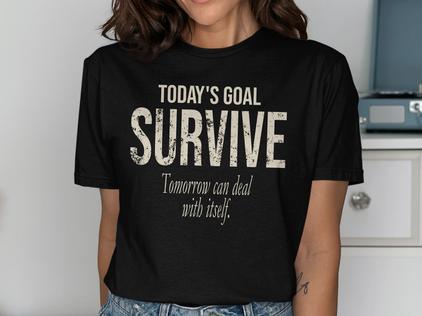 Black t-shirt with text "TODAY'S GOAL SURVIVE Tomorrow can deal with itself."