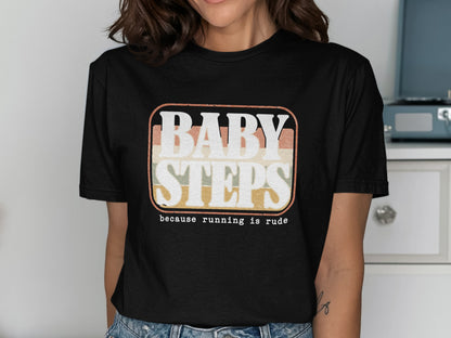 Black t-shirt with retro graphic text "BABY STEPS because running is rude."