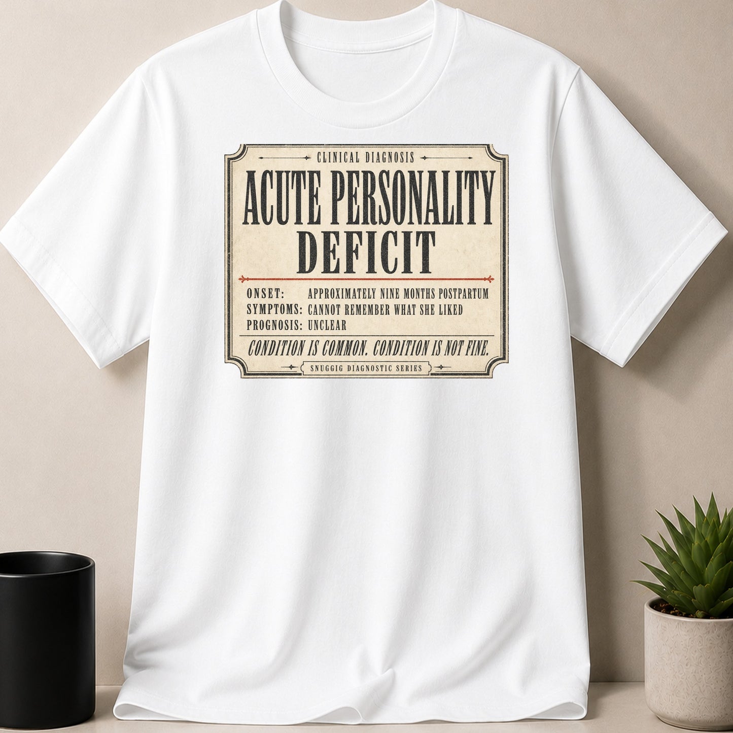 White t-shirt with "Acute Personality Deficit" diagnostic text and humorous details.