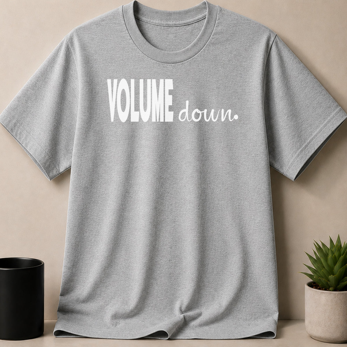 Grey t-shirt with white text "VOLUME down."