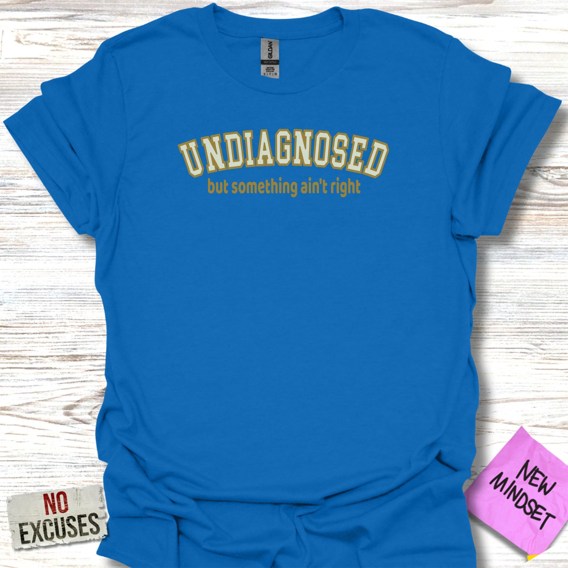 Blue t-shirt with "undiagnosed but something ain't right" in yellow text.