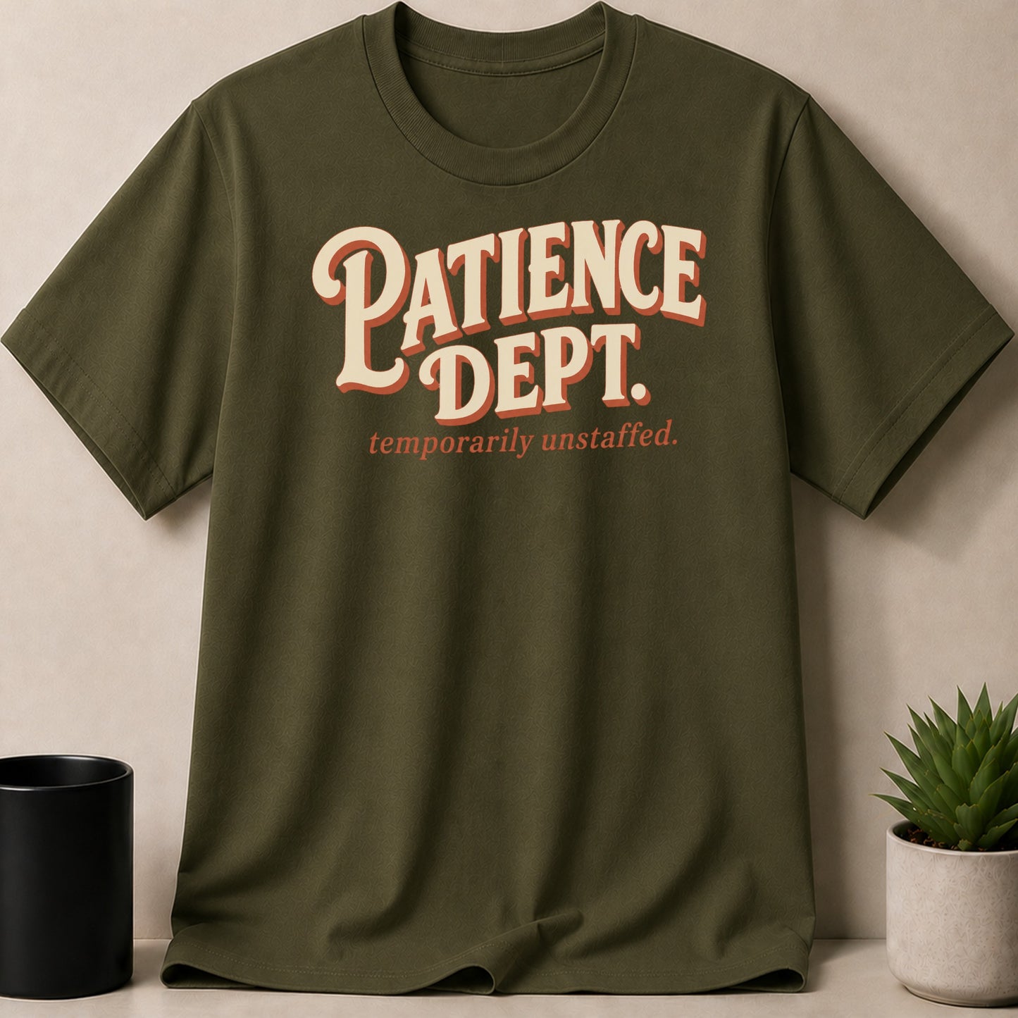 Green t-shirt with "PATIENCE DEPT. temporarily unstaffed." text.