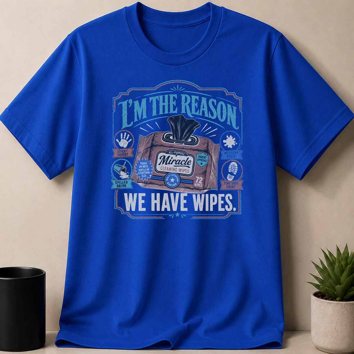 Blue t-shirt with "I'm the reason we have wipes" and Miracle wipes graphic.