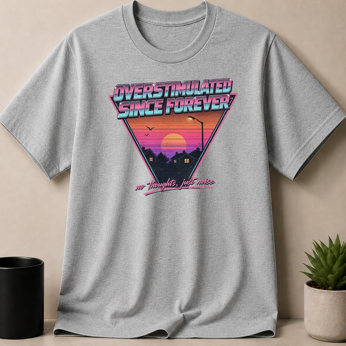 Grey t-shirt with "OVERSTIMULATED SINCE FOREVER" and "no thoughts, just noise" graphics.
