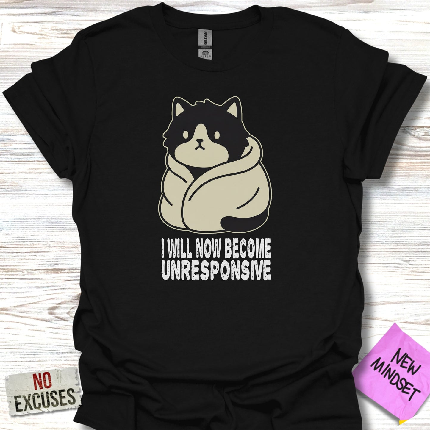 Black t-shirt with cartoon cat wrapped in blanket saying "I will now become unresponsive."