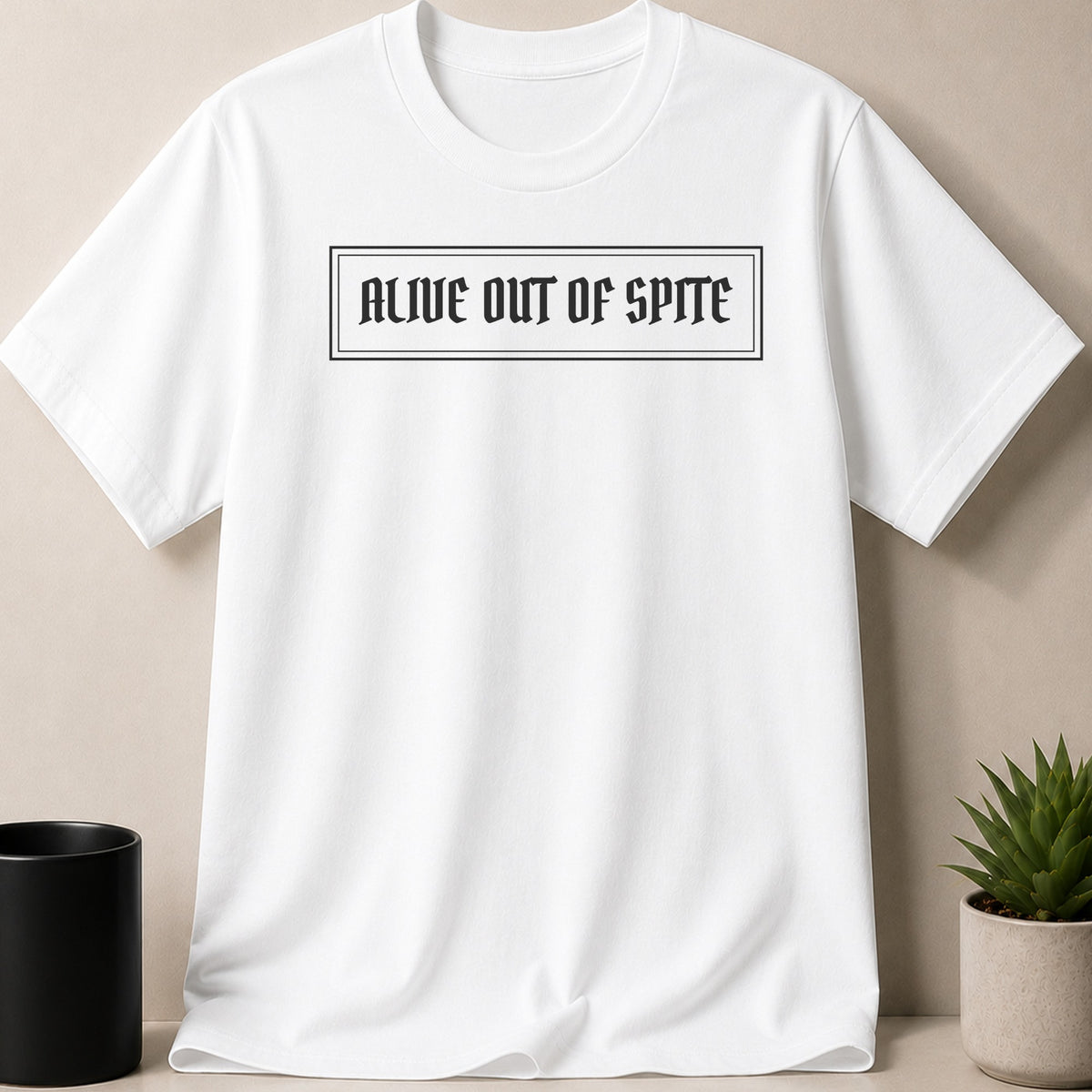 White t-shirt with "ALIVE OUT OF SPITE" text in a black box.