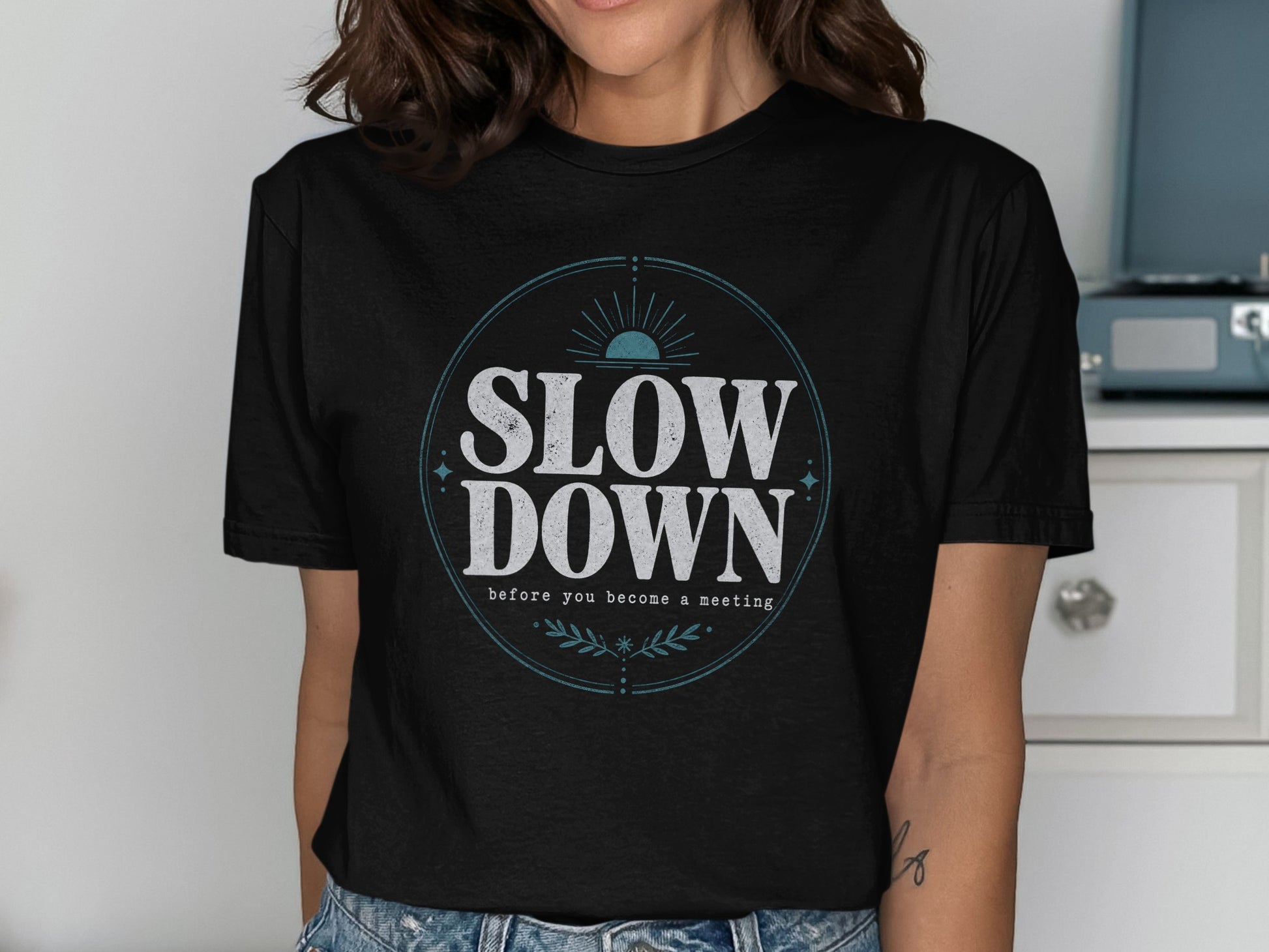 Black t-shirt with circular graphic reading "SLOW DOWN".