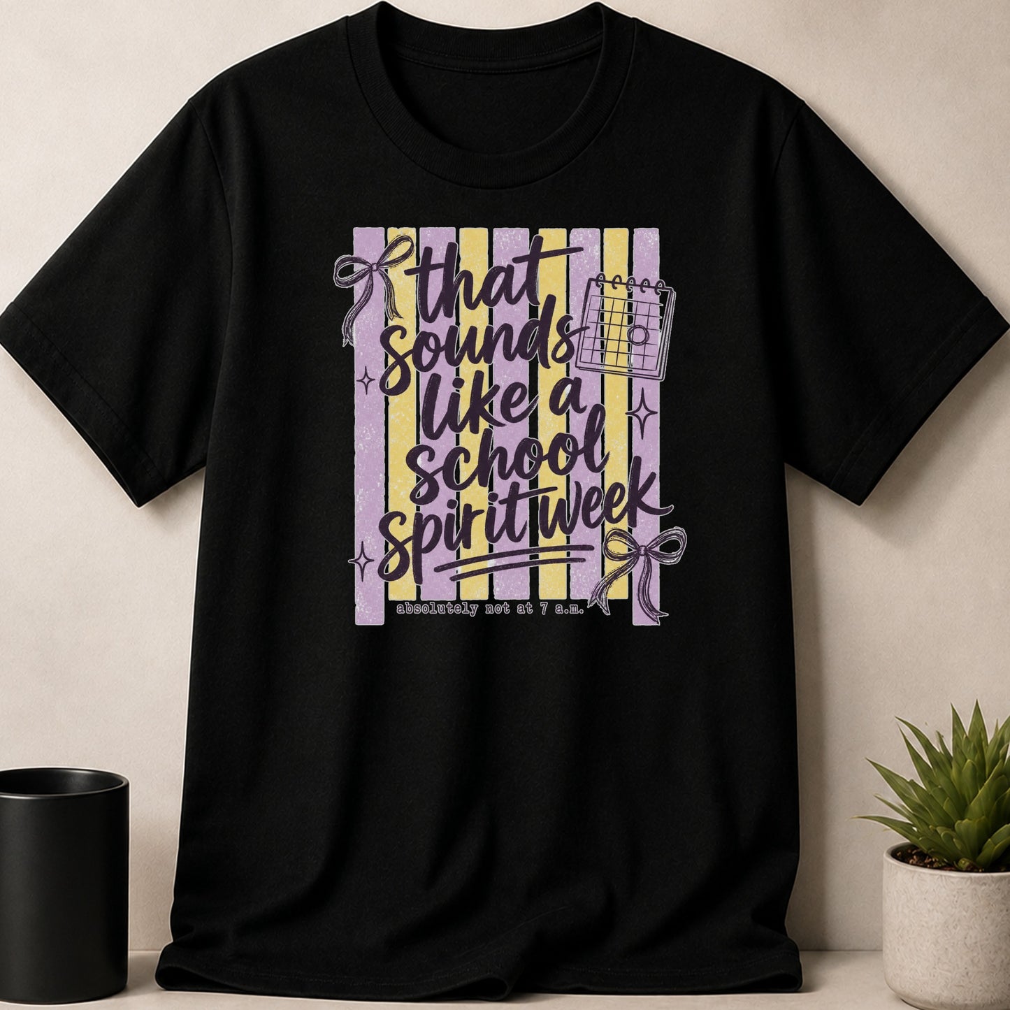 Black t-shirt featuring "That sounds like a school spirit week" text and calendar graphic.