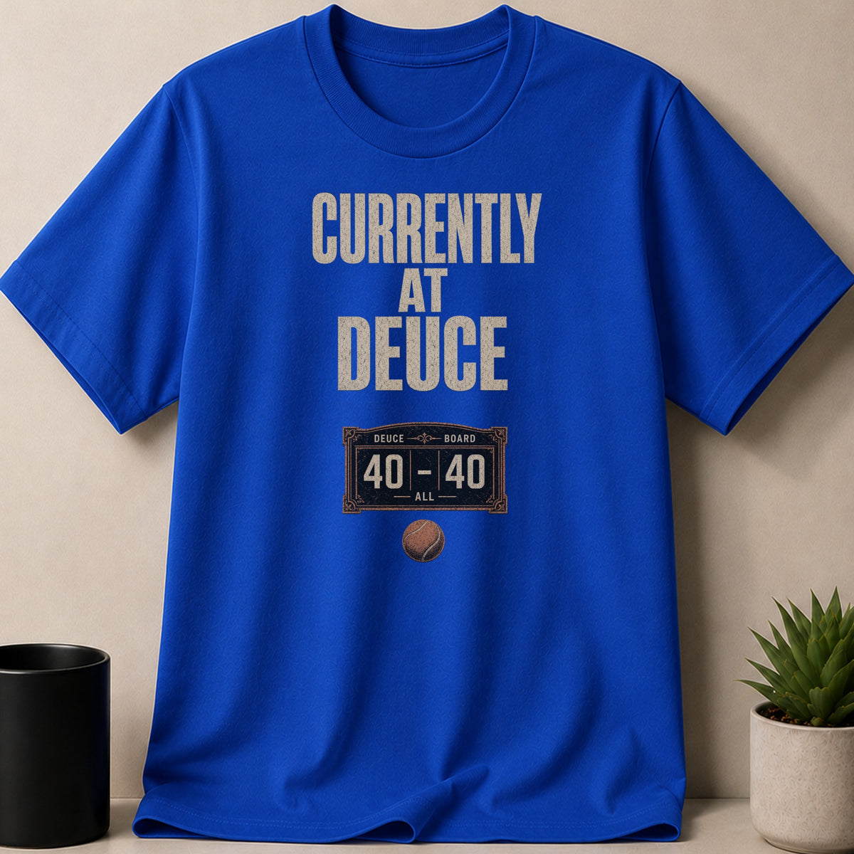 Blue t-shirt with "CURRENTLY AT DEUCE" and a tennis score graphic.