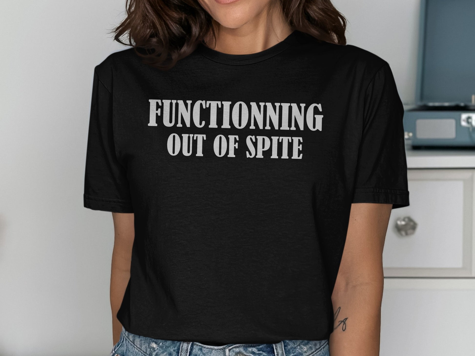Black t-shirt with white text reading "FUNCTIONNING OUT OF SPITE".