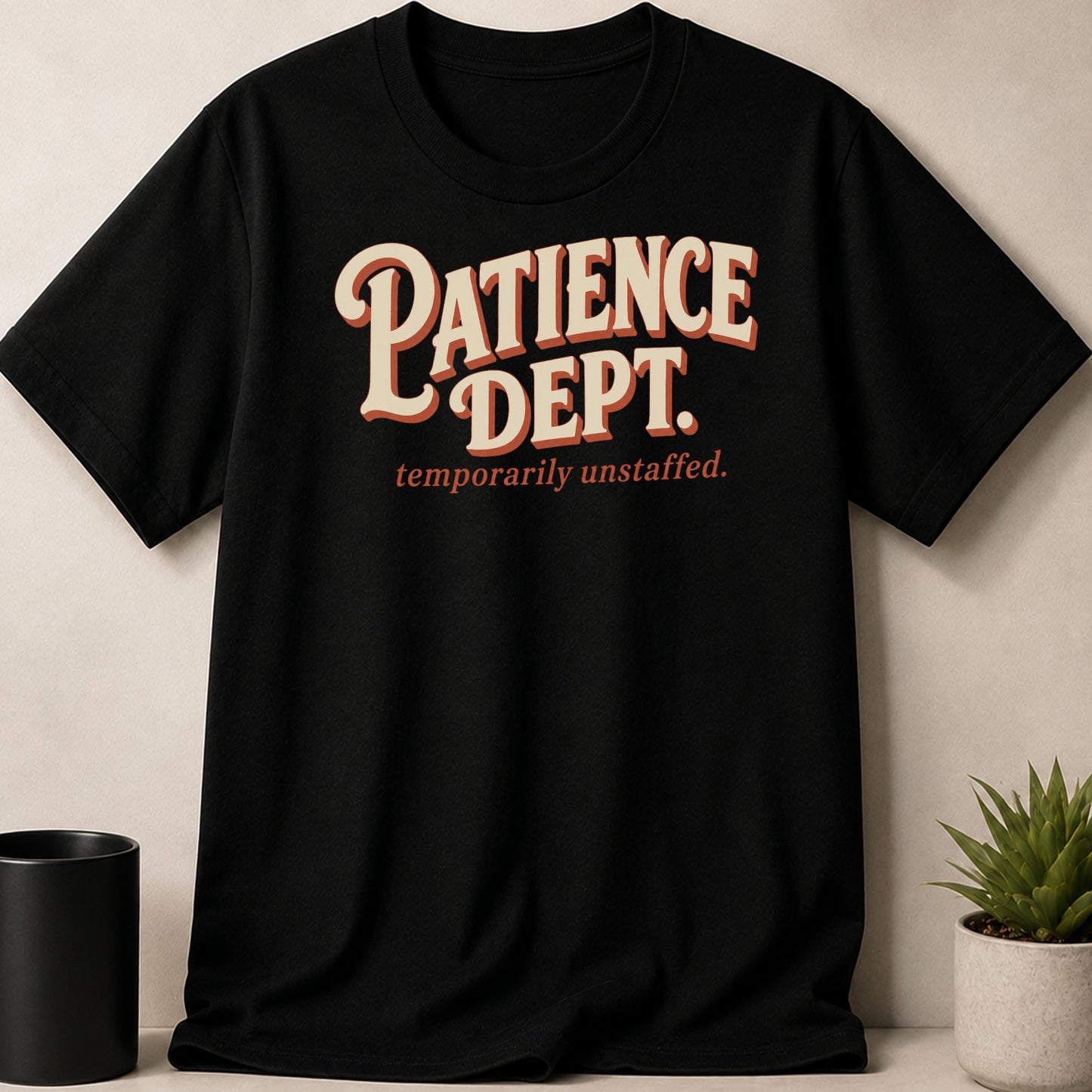 Black t-shirt with "Patience Dept. temporarily unstaffed." text graphic.