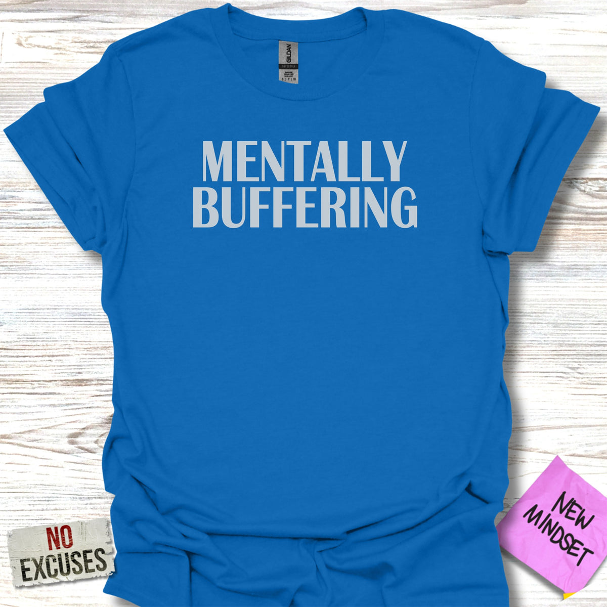 Blue t-shirt with white text "MENTALLY BUFFERING" and a pink sticky note.
