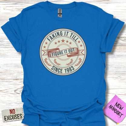 Blue t-shirt with "FAKING IT TILL I FIGURE IT OUT SINCE 1983" text.