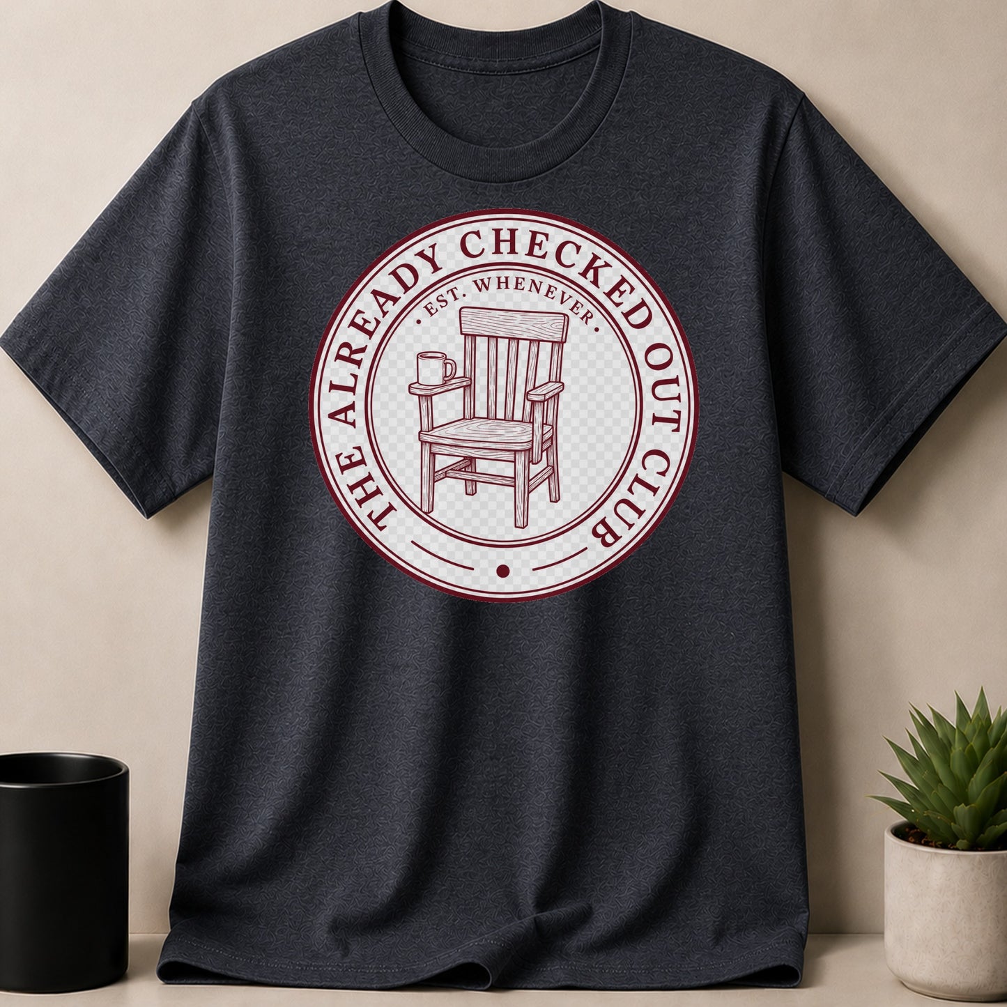 Dark t-shirt with a circular graphic of a wooden chair and coffee mug.