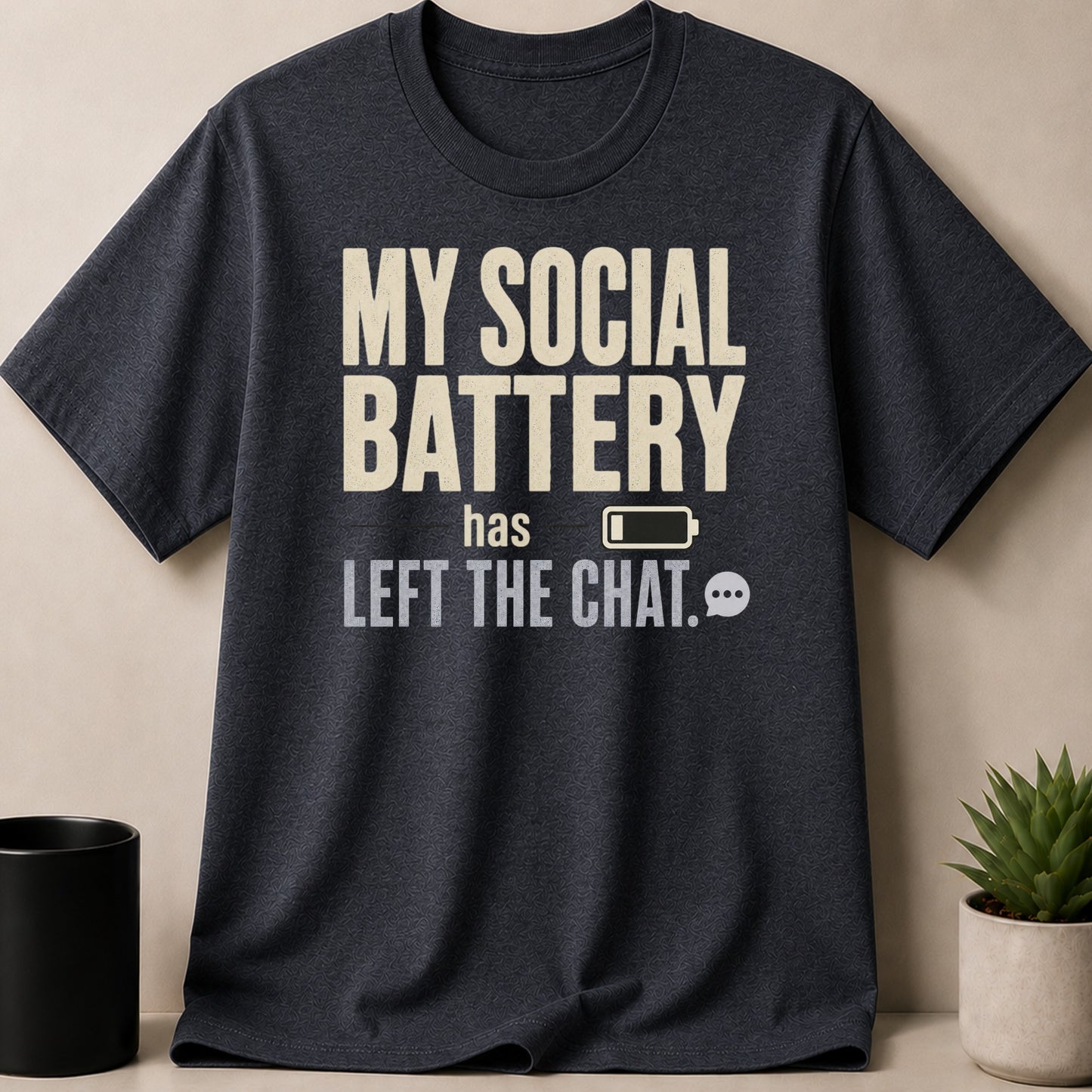 Dark t-shirt with cream text: My social battery has left the chat.