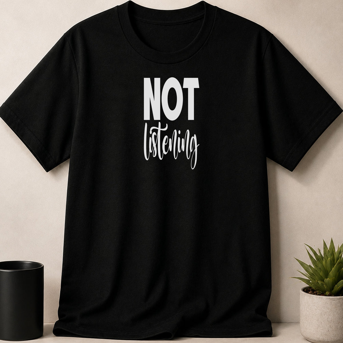 Black t-shirt with white text reading "NOT listening."