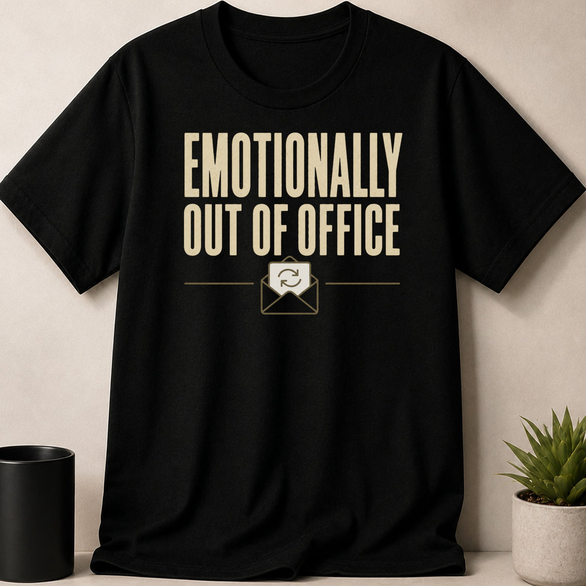 Black t-shirt with "EMOTIONALLY OUT OF OFFICE" text and an envelope icon with refresh symbol.
