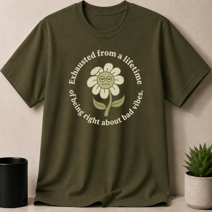 Green t-shirt with a distressed flower graphic and text: "Exhausted from a lifetime of being right about bad vibes."