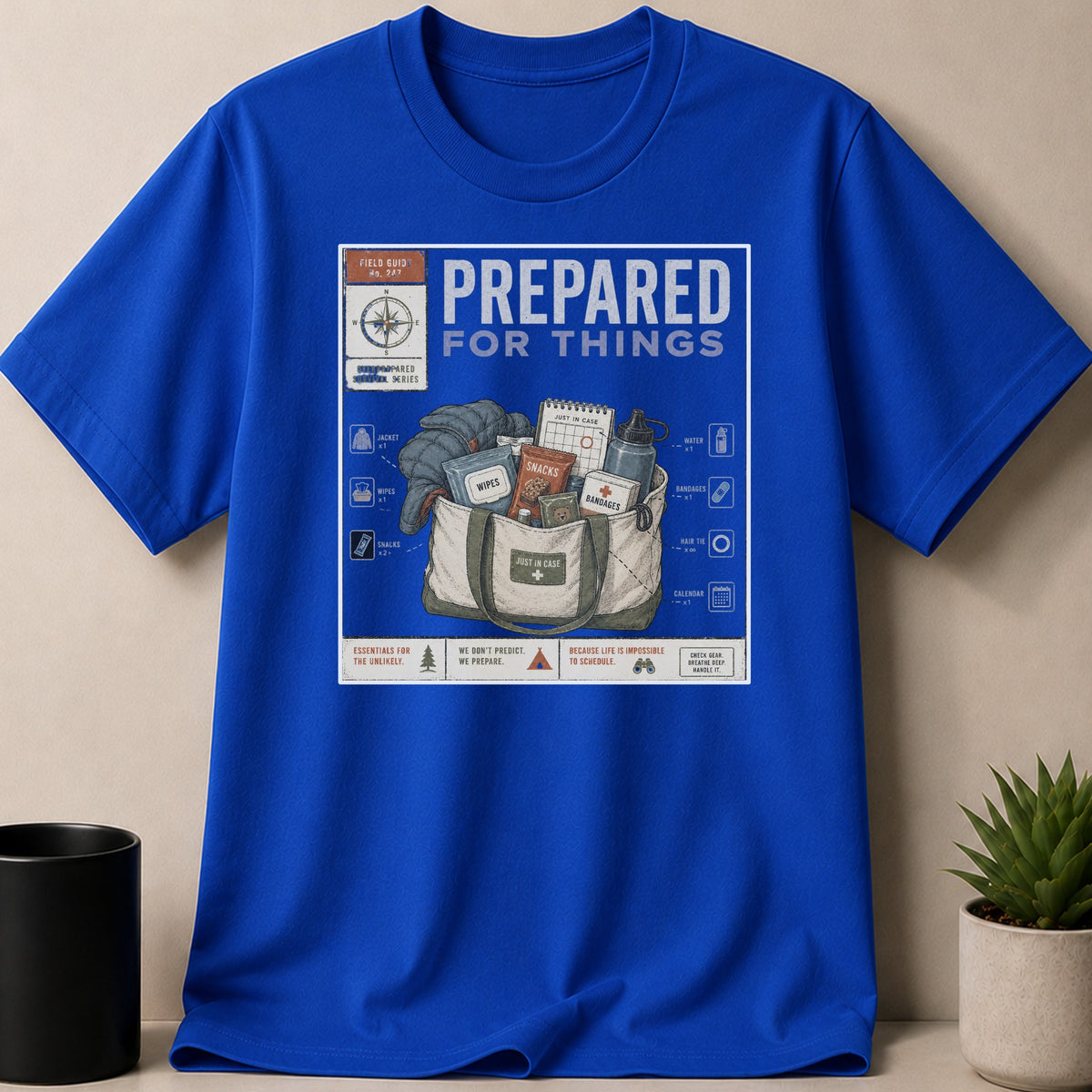 Blue t-shirt with "Prepared For Things" graphic depicting survival gear in a bag.