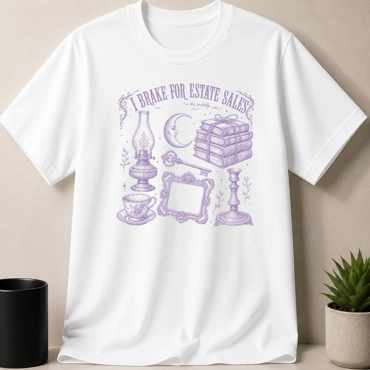 White t-shirt with purple sketch of "I brake for estate sales" and vintage items.