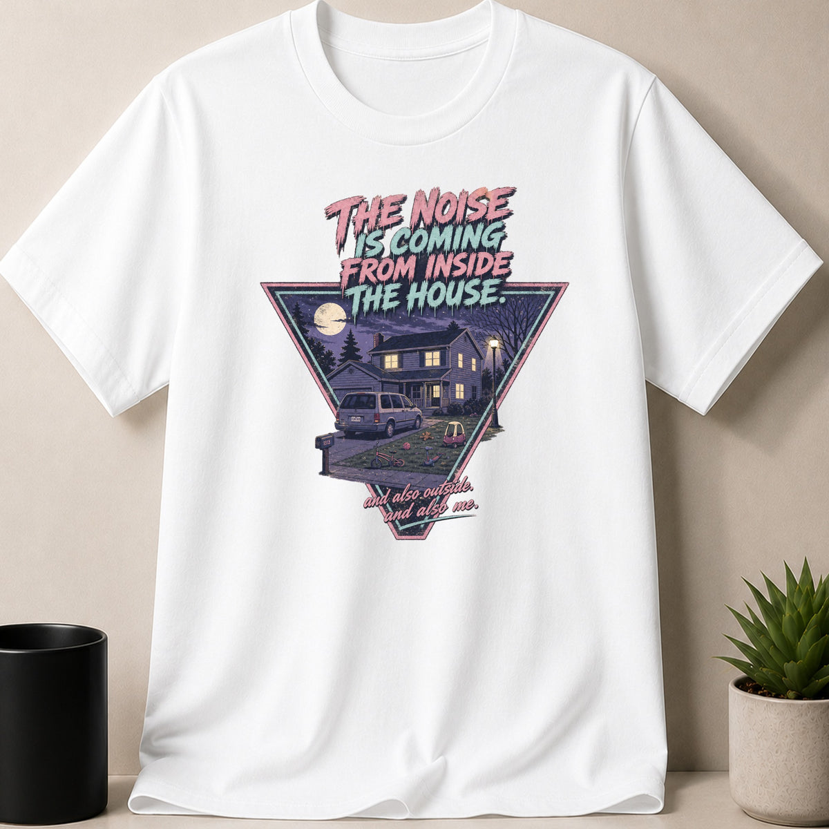 White t-shirt with text and graphic of a house at night.