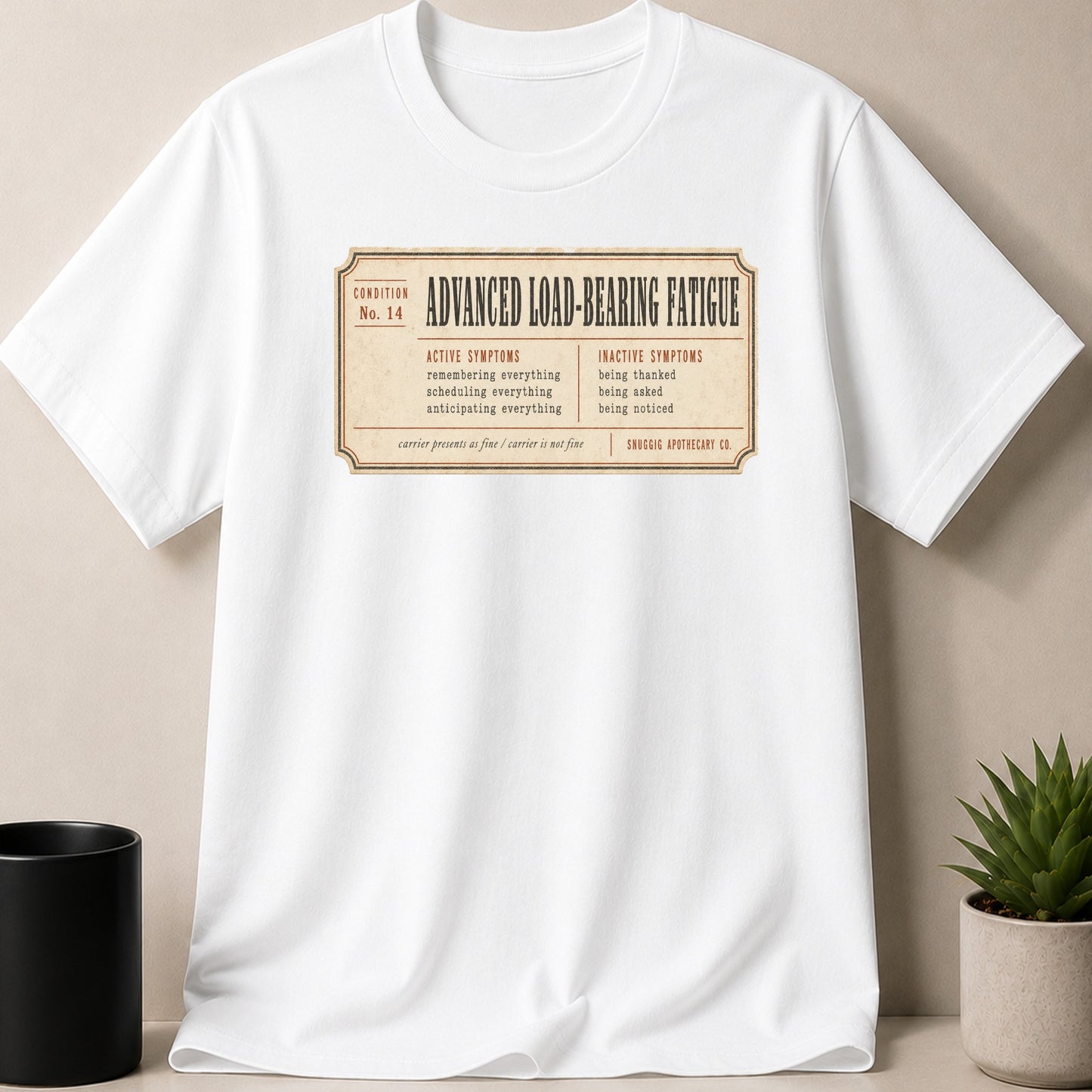White t-shirt with "Advanced Load-Bearing Fatigue" printed on a vintage-style label.