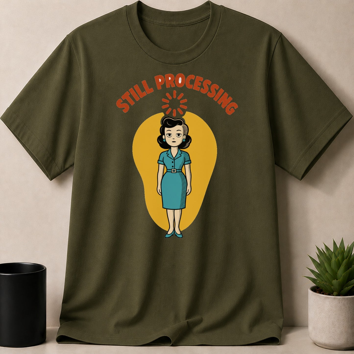 Olive green t-shirt with a cartoon woman and "Still Processing" text.