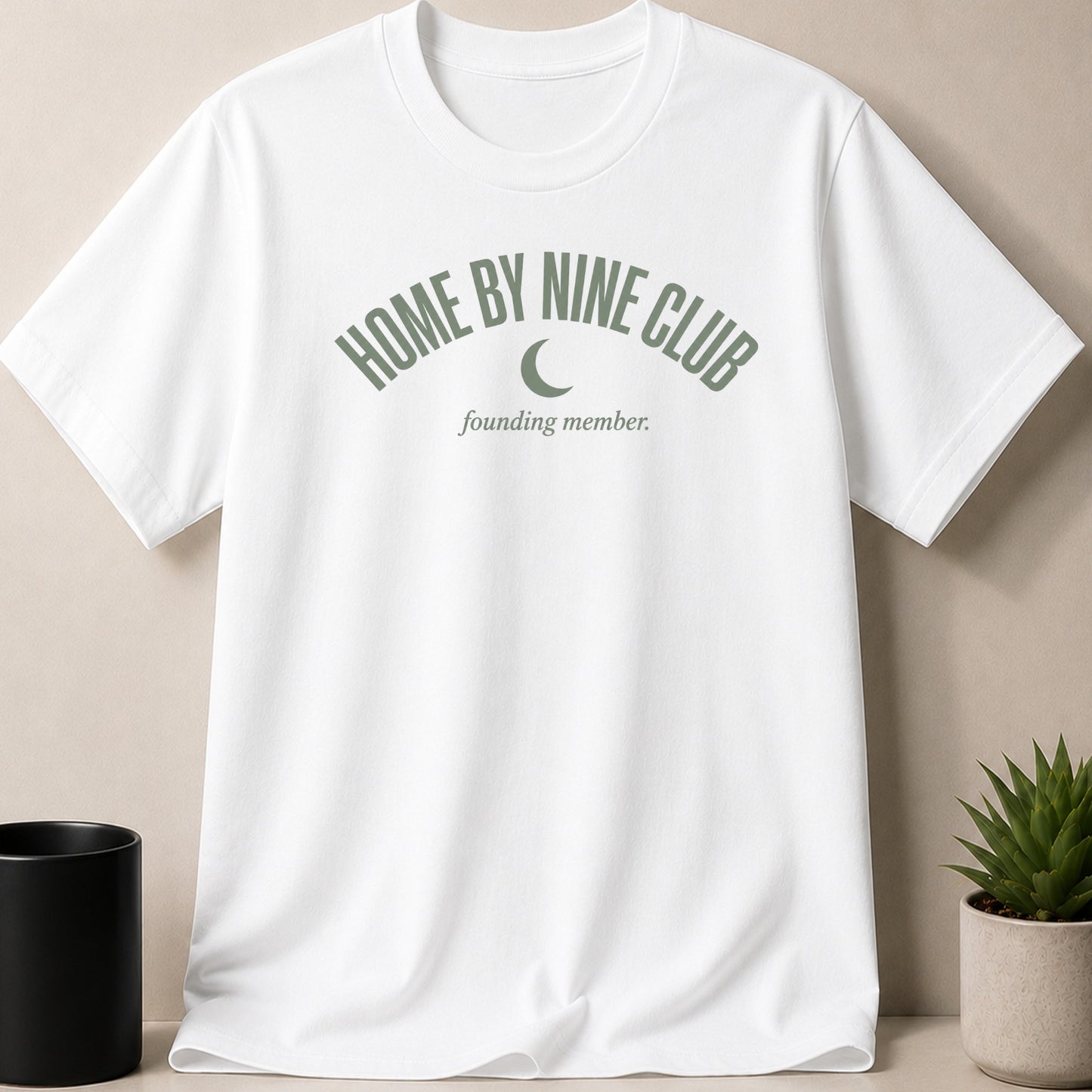 White t-shirt with "HOME BY NINE CLUB founding member" and crescent moon graphic.