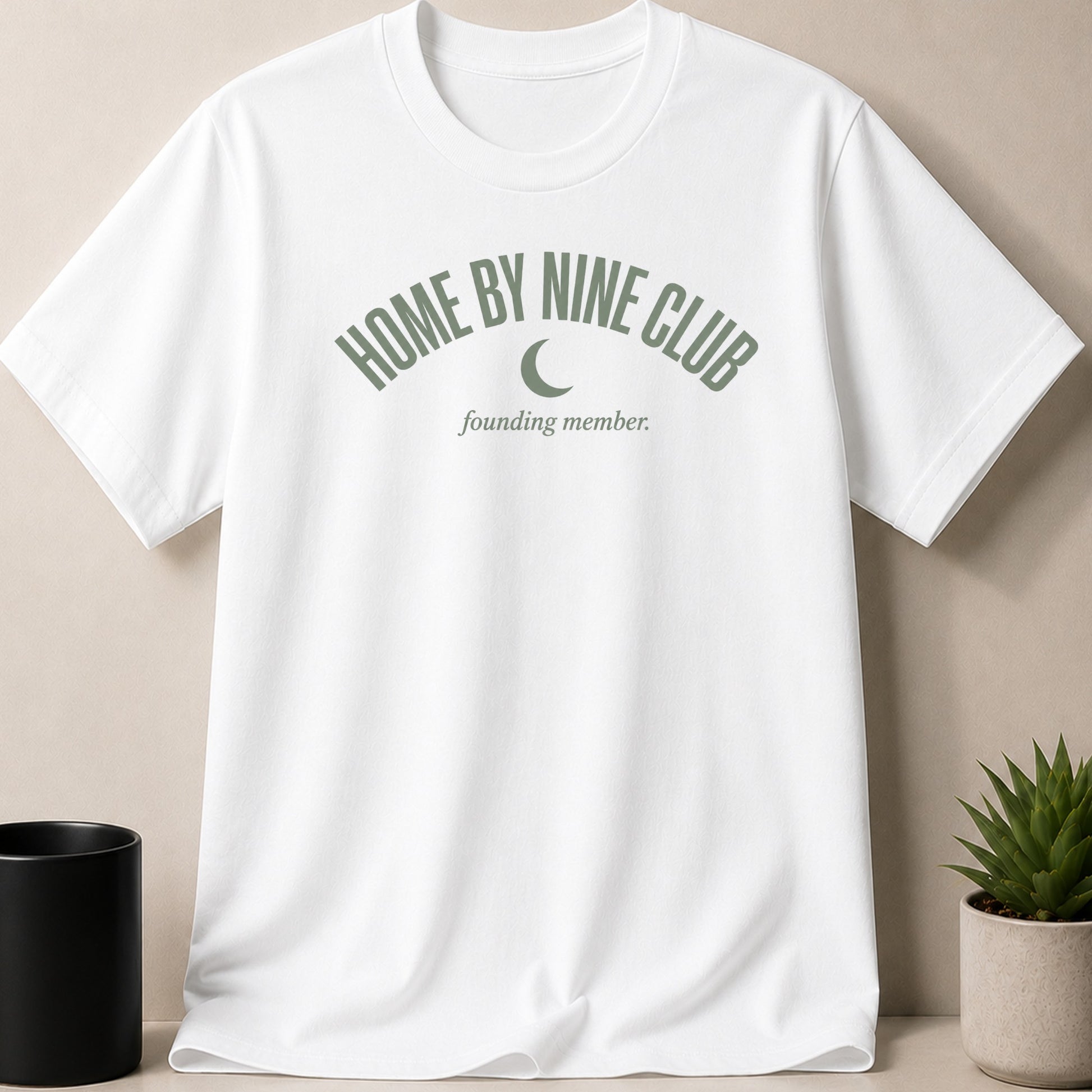 White t-shirt with "HOME BY NINE CLUB founding member" and crescent moon graphic.