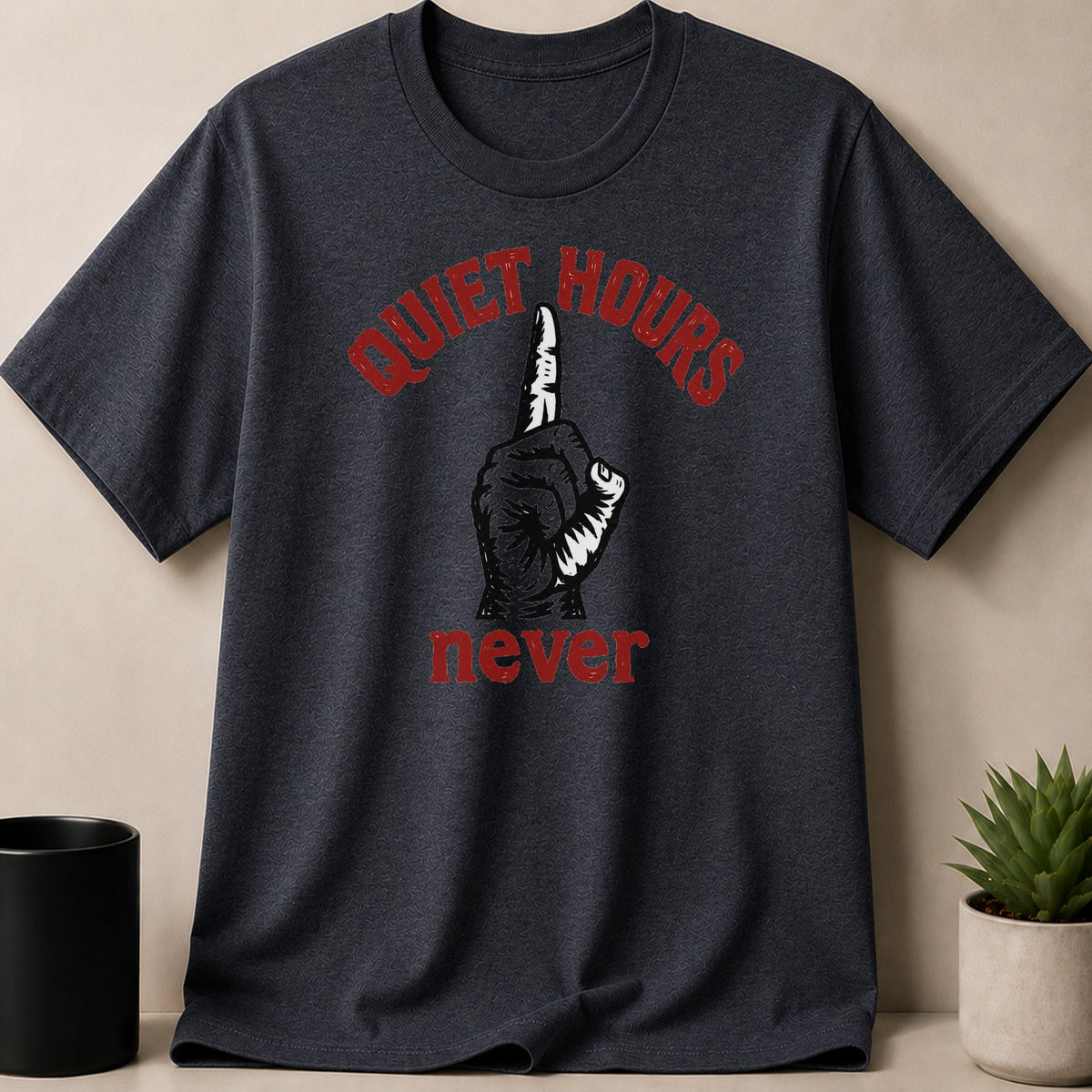 Dark grey t-shirt with red text "QUIET HOURS" above a finger to lips gesture and "never".