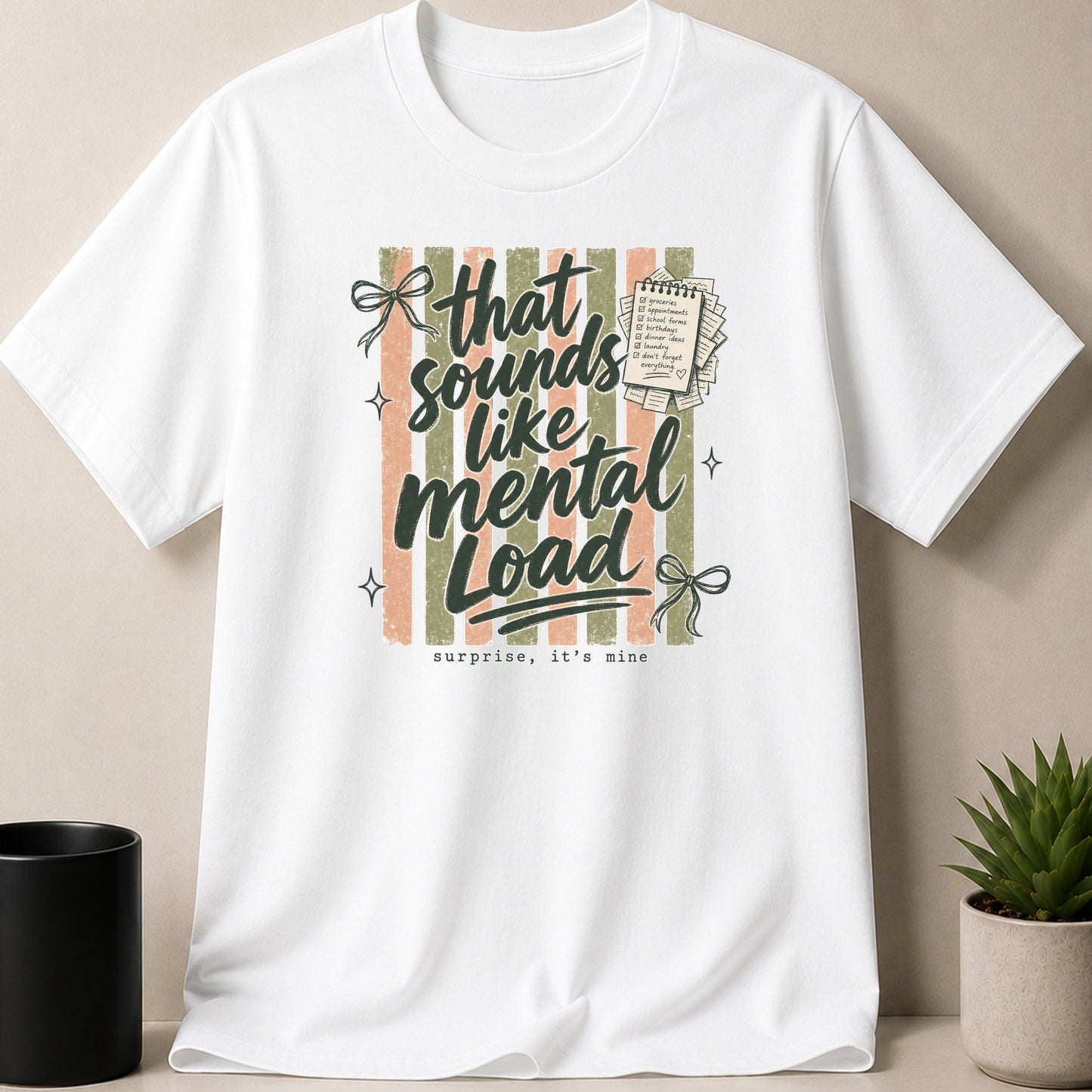 White t-shirt with "that sounds like mental load surprise, it's mine" graphic.
