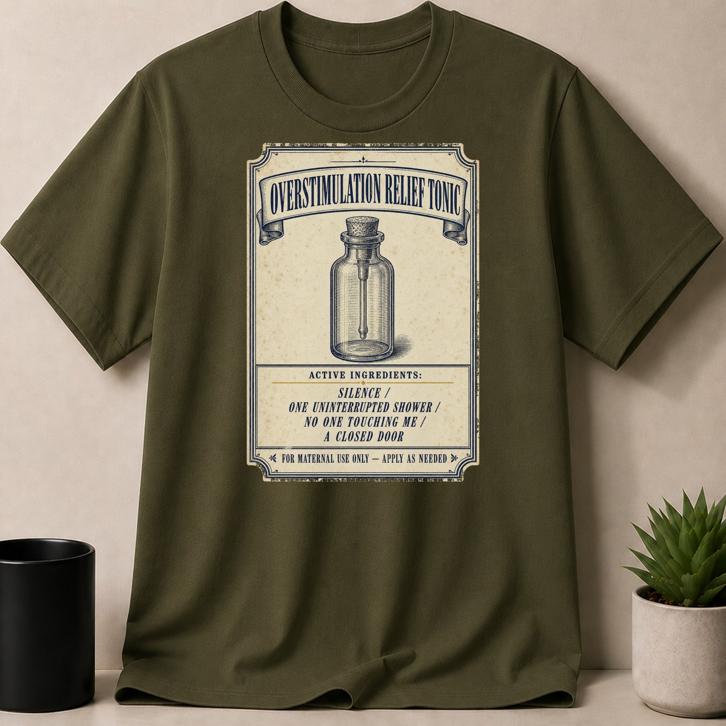 Olive green t-shirt with "Overstimulation Relief Tonic" graphic.