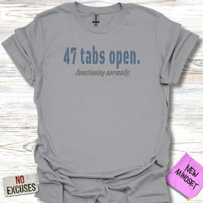Gray t-shirt with "47 tabs open. functioning normally." in blue text.