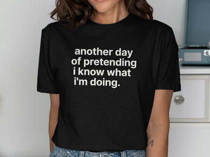 Black t-shirt with white text saying "another day of pretending i know what i'm doing."