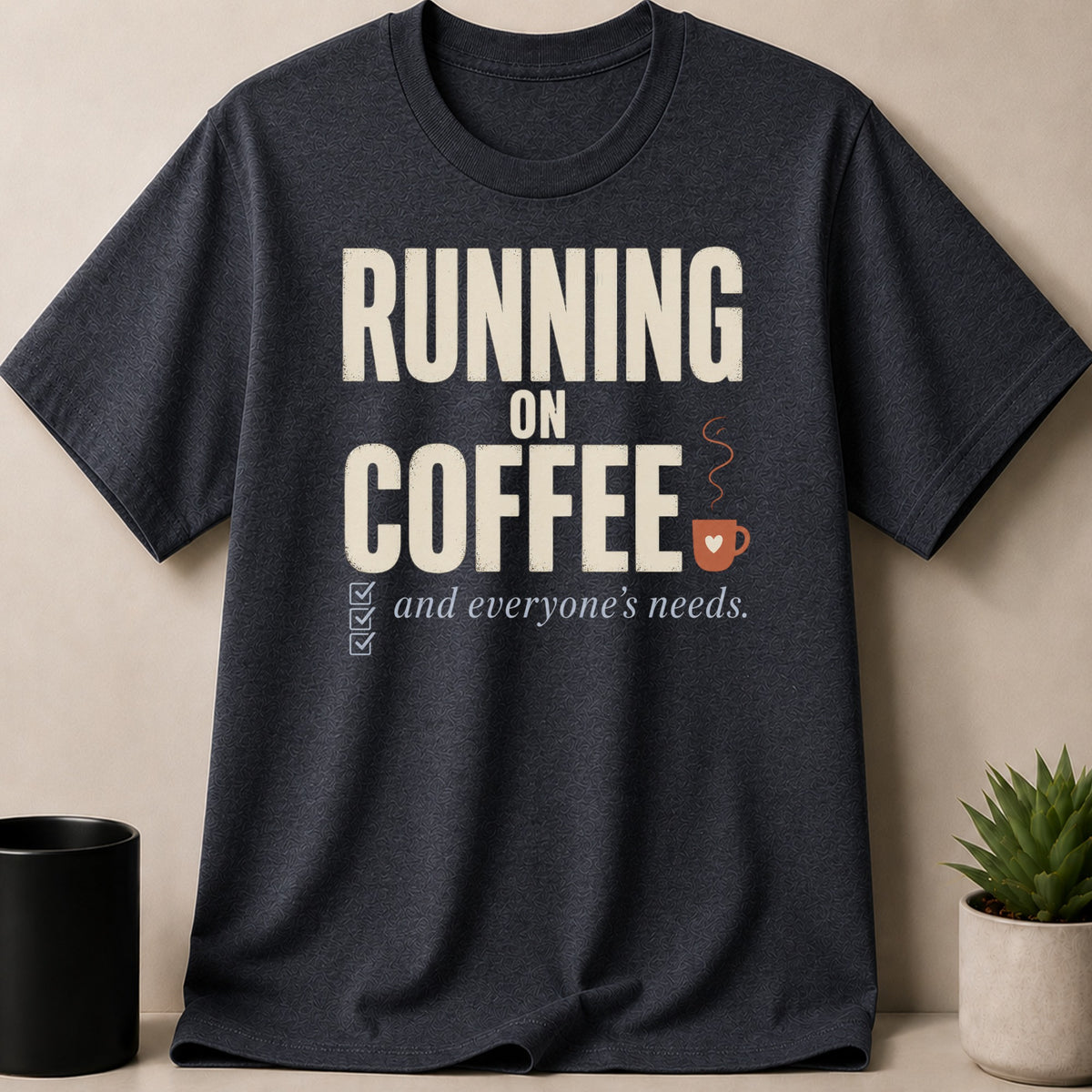 Dark t-shirt with "RUNNING ON COFFEE and everyone's needs." text design.