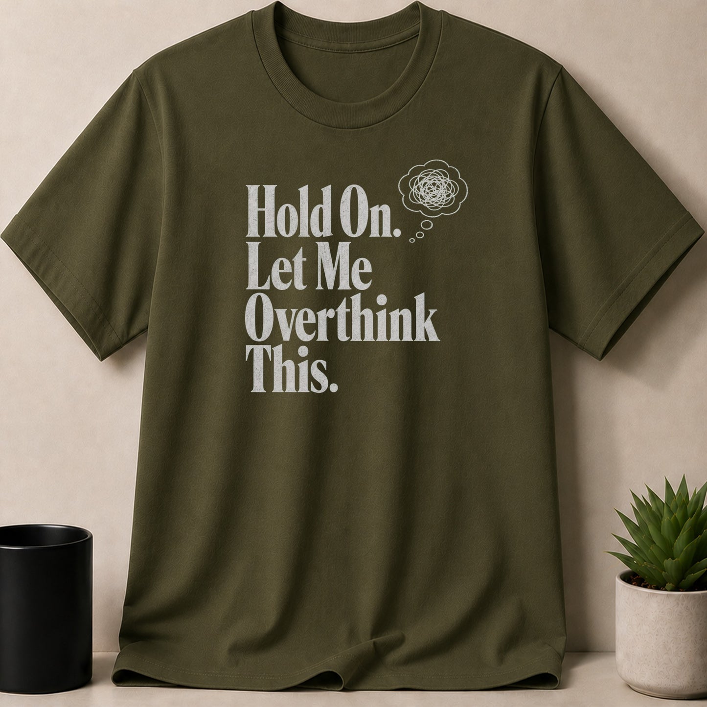 Olive green t-shirt with white text "Hold On. Let Me Overthink This."