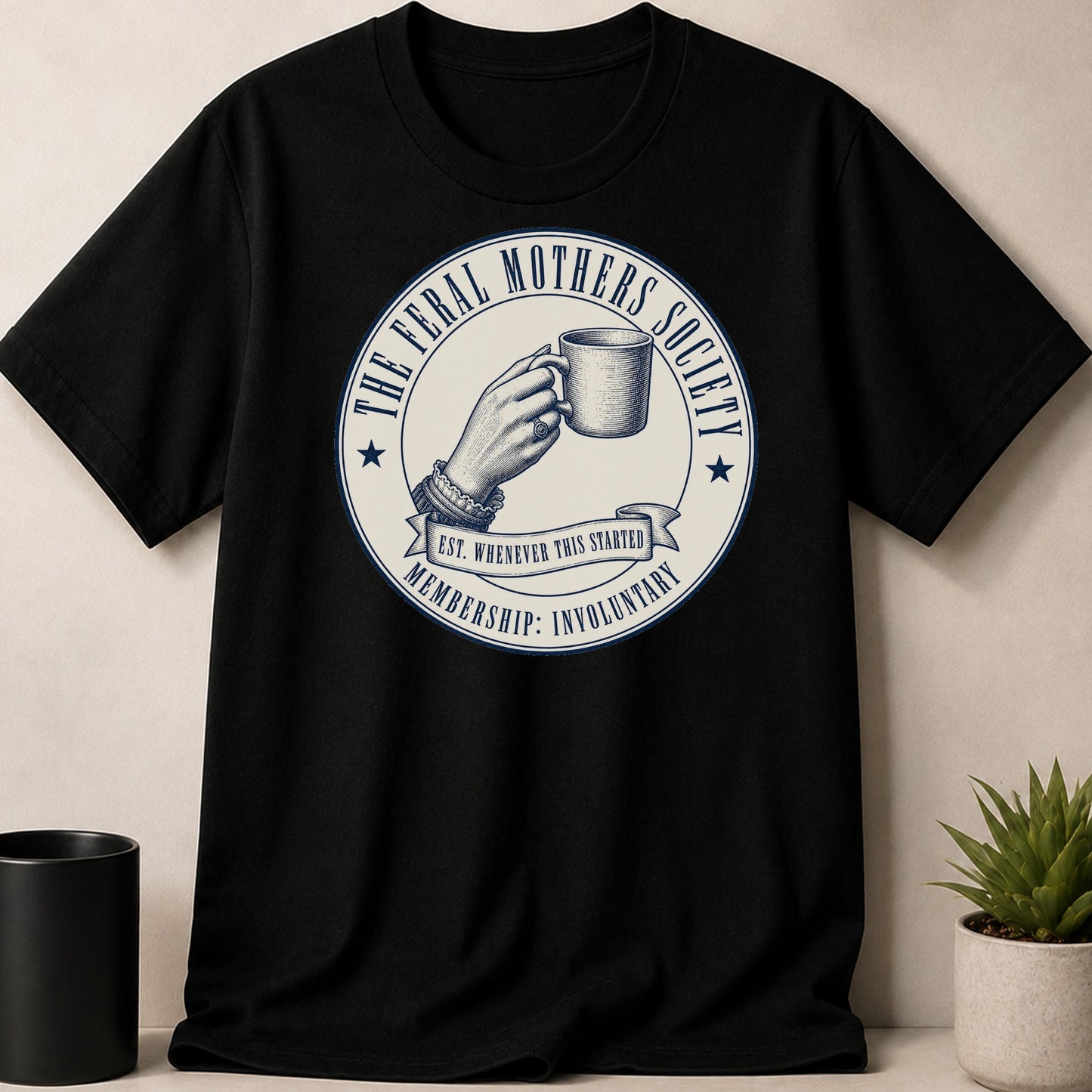 Black t-shirt with "The Feral Mothers Society" in a circular badge.