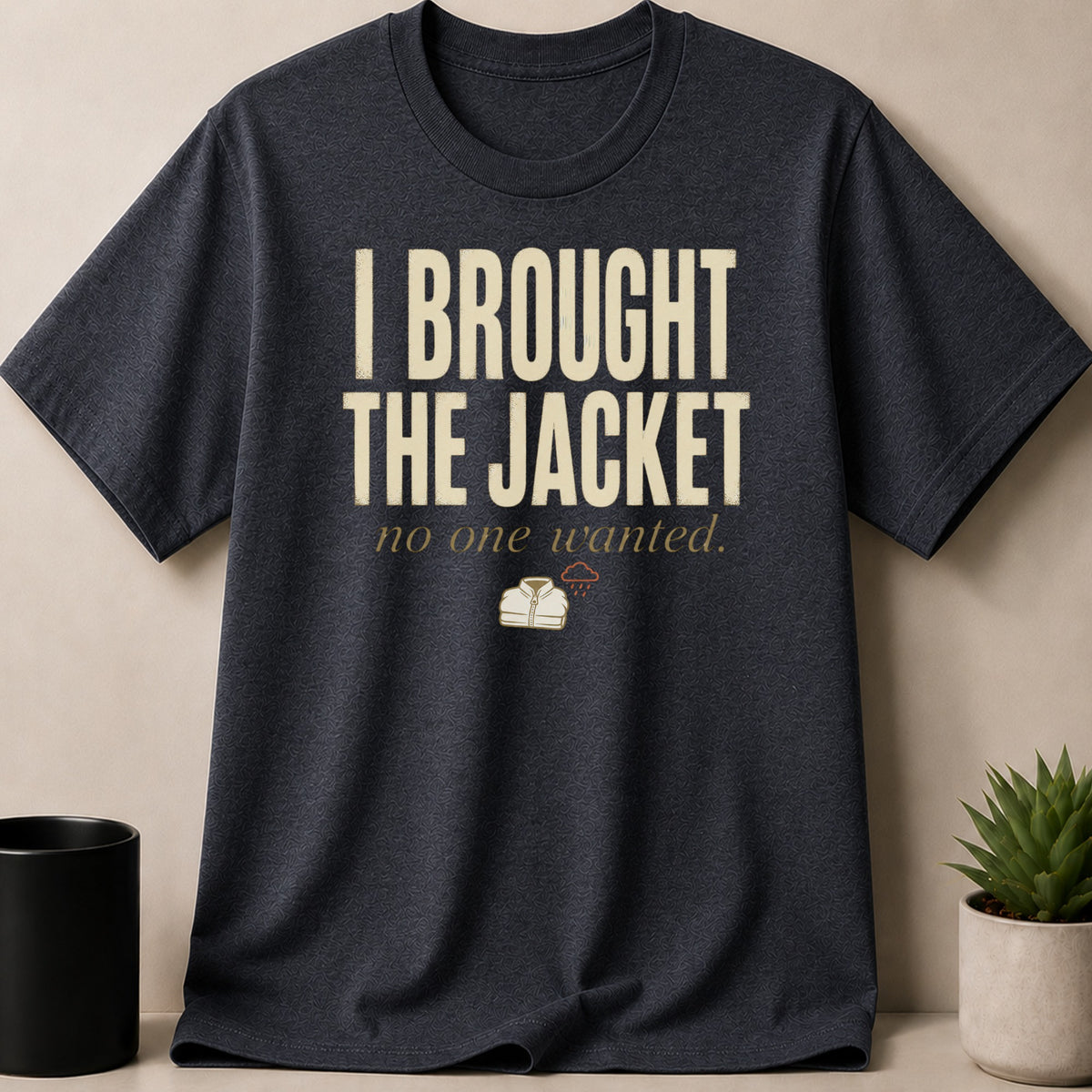 Dark grey t-shirt with text "I BROUGHT THE JACKET no one wanted" and graphics.